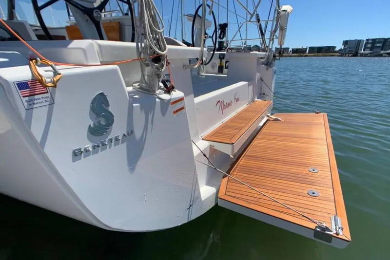 Slide: The Image of 2020 Beneteau Oceanis 46.1 yacht with teak swim platform, docked in sunny marina. - 14