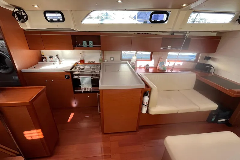 Slide: The Image of Luxurious interior of 2020 Beneteau Oceanis 46.1 yacht with modern kitchen and seating area. - 18