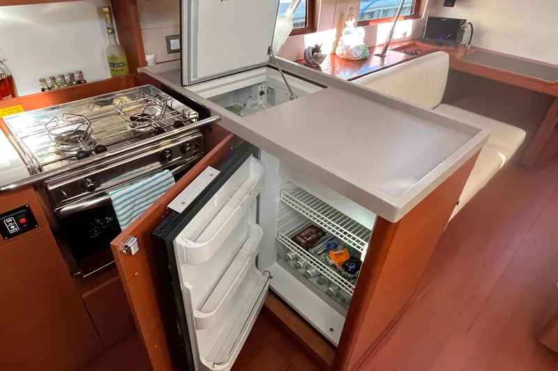 Slide: The Image of Interior of 2020 Beneteau Oceanis 46.1 yacht kitchen with stove and open fridge. - 19