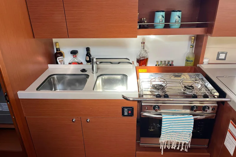 Slide: The Image of Modern galley kitchen in 2020 Beneteau Oceanis 46.1 yacht with dual sinks and stove. - 20