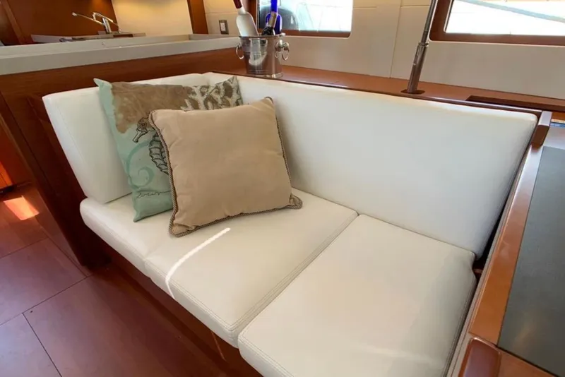 Slide: The Image of Luxurious interior seating on 2020 Beneteau Oceanis 46.1 yacht with decorative pillows. - 24