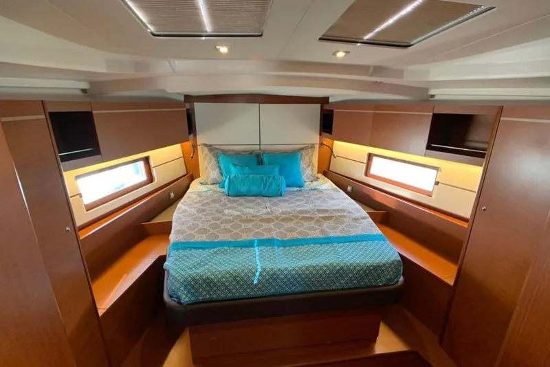 Slide: The Image of Luxurious cabin interior of 2020 Beneteau Oceanis 46.1 yacht with elegant bedding and wood finish. - 25