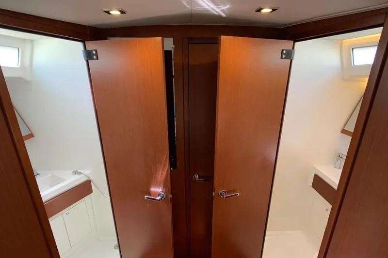 Slide: The Image of Interior of 2020 Beneteau Oceanis 46.1 yacht, featuring dual wooden doors and modern bathroom. - 26