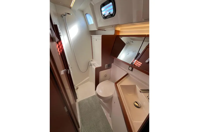 Slide: The Image of Modern bathroom in 2020 Beneteau Oceanis 46.1 yacht, featuring shower, sink, and toilet. - 32