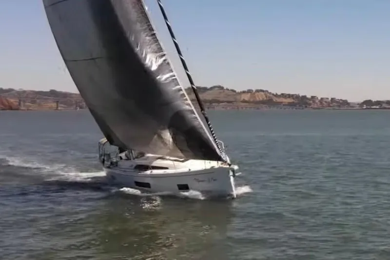 Slide: The Image of 2020 Beneteau Oceanis 46.1 sailing on open water with scenic coastal backdrop. - 36