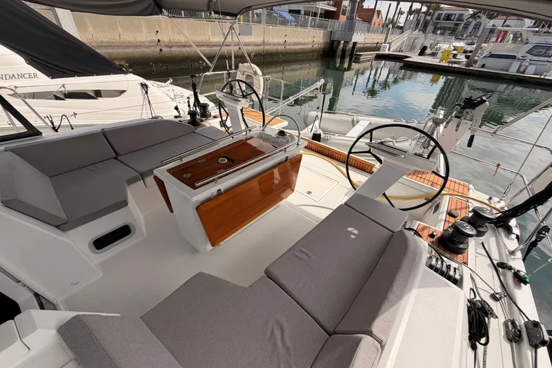 Slide: The Image of 2020 Beneteau Oceanis 46.1 yacht cockpit with seating and steering wheel in marina. - 38