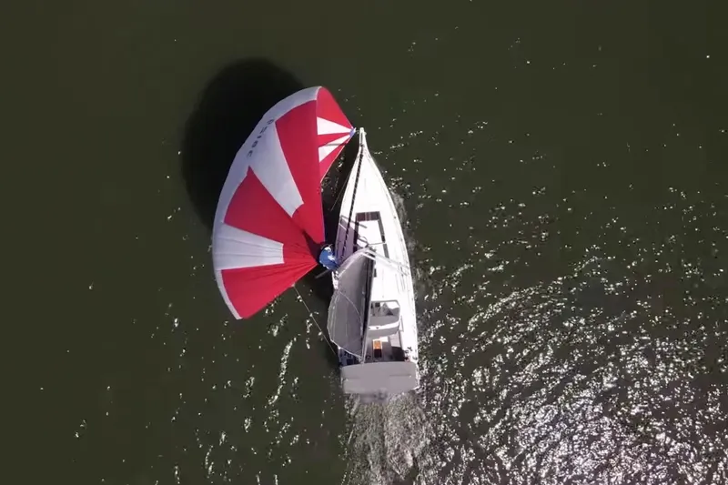 Slide: The Image of Aerial view of 2020 Beneteau Oceanis 46.1 sailboat with red and white spinnaker. - 4