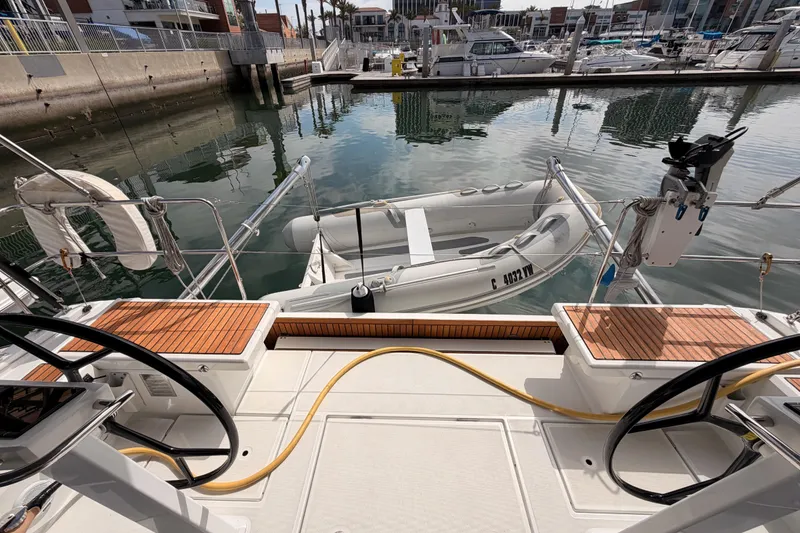 Slide: The Image of Beneteau Oceanis 46.1 yacht deck with dinghy, docked in a marina, 2020 model. - 40
