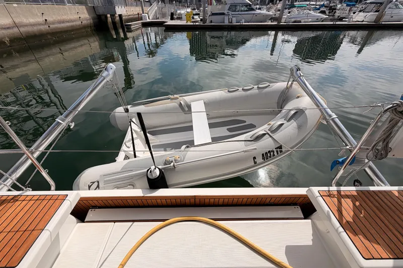 Slide: The Image of Beneteau Oceanis 46.1 (2020) with inflatable dinghy docked at marina. - 42