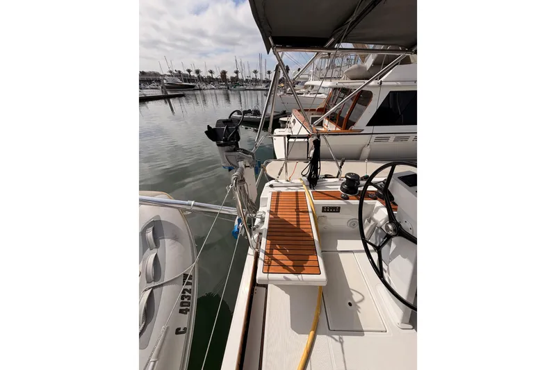 Slide: The Image of 2020 Beneteau Oceanis 46.1 yacht deck with wooden accents in marina setting. - 43
