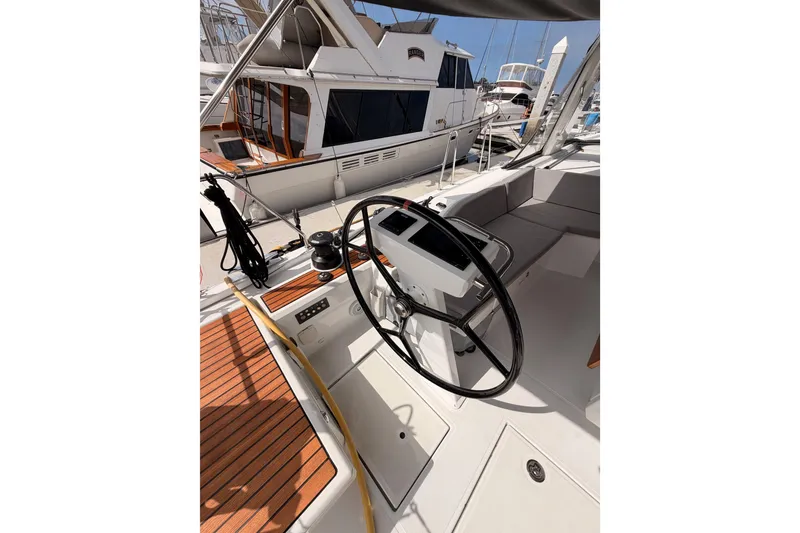 Slide: The Image of Cockpit of 2020 Beneteau Oceanis 46.1 yacht with steering wheel and teak decking. - 44