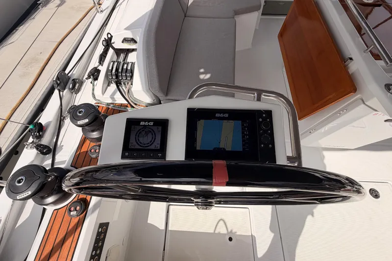 Slide: The Image of Cockpit of 2020 Beneteau Oceanis 46.1 with navigation instruments and steering wheel. - 47