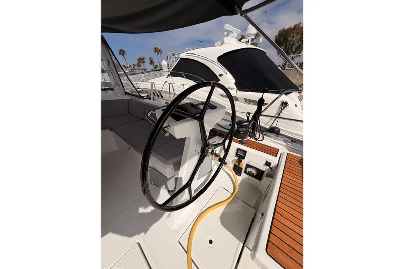 Slide: The Image of Cockpit of 2020 Beneteau Oceanis 46.1 sailboat with steering wheel and teak decking. - 48