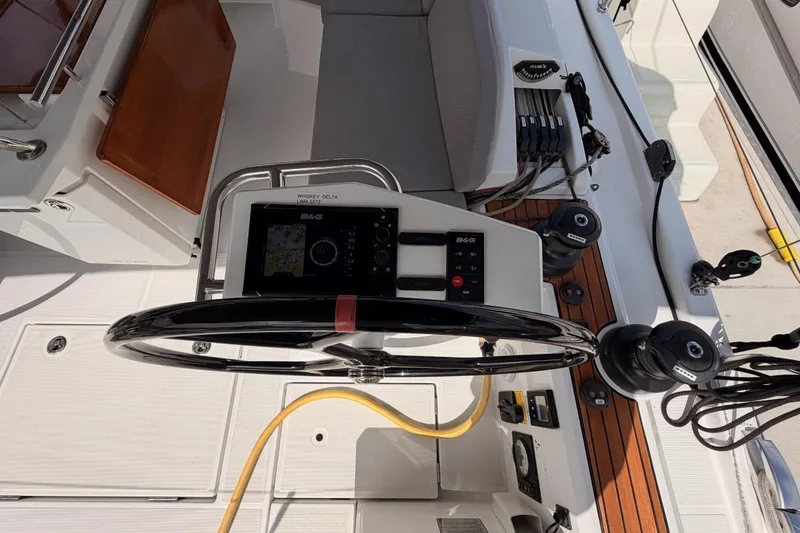 Slide: The Image of Cockpit of 2020 Beneteau Oceanis 46.1 sailboat with steering wheel and navigation equipment. - 49