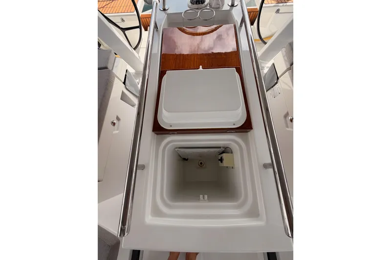 Slide: The Image of Cockpit view of 2020 Beneteau Oceanis 46.1 sailboat with open storage compartment. - 56