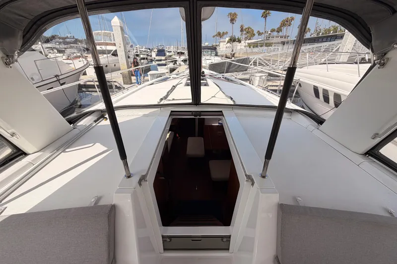 Slide: The Image of Beneteau Oceanis 46.1 yacht cockpit view, showcasing marina and open hatch, 2020 model. - 57