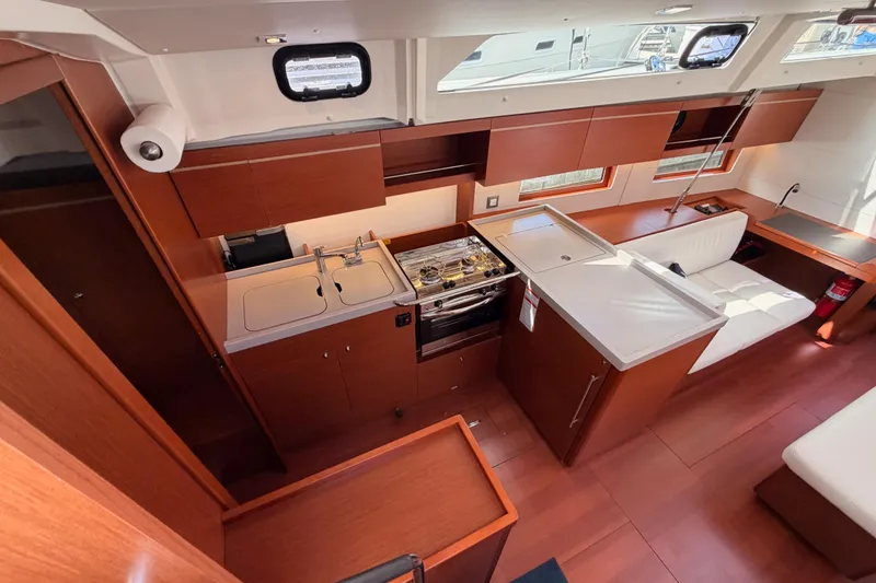 Slide: The Image of Interior of 2020 Beneteau Oceanis 46.1 yacht, featuring modern kitchen and seating area. - 61