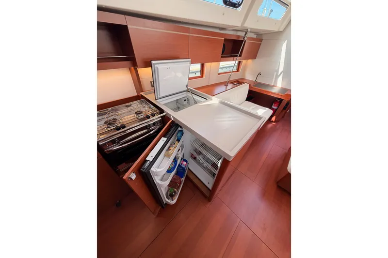 Slide: The Image of Interior of 2020 Beneteau Oceanis 46.1 yacht kitchen with open fridge and stove. - 63