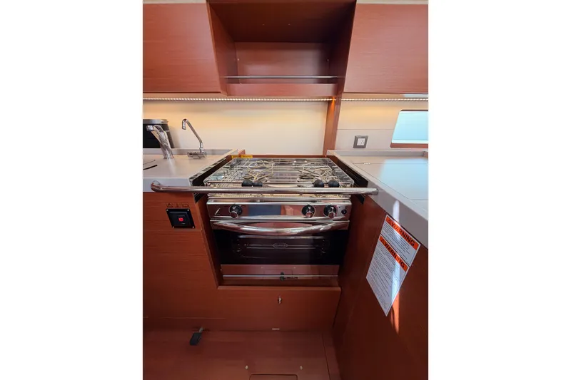 Slide: The Image of Modern kitchen area in a 2020 Beneteau Oceanis 46.1 yacht with stove and sink. - 64