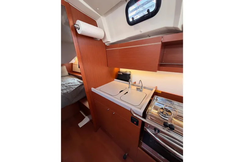 Slide: The Image of Interior of 2020 Beneteau Oceanis 46.1 yacht kitchen with sink and stove. - 65