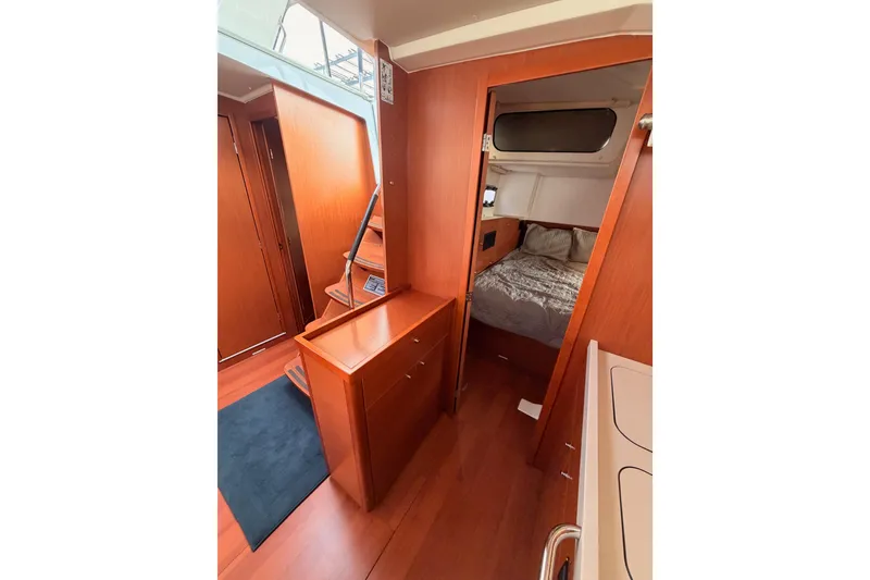 Slide: The Image of Interior of 2020 Beneteau Oceanis 46.1 yacht, featuring cozy cabin and wooden finishes. - 67