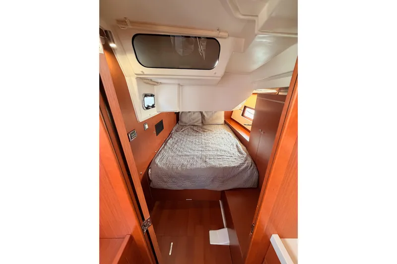 Slide: The Image of Interior cabin of 2020 Beneteau Oceanis 46.1 yacht with cozy bed and wooden finish. - 68