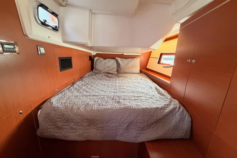 Slide: The Image of Cozy cabin interior of 2020 Beneteau Oceanis 46.1 yacht with wooden finish and comfortable bedding. - 69