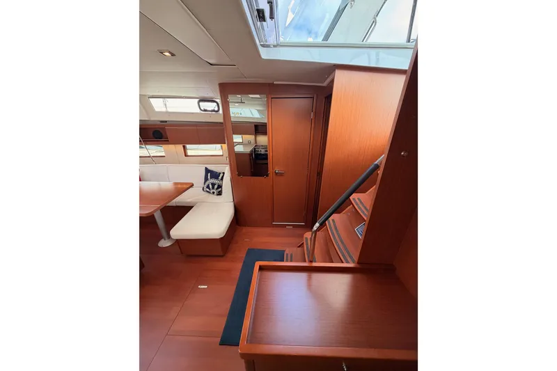 Slide: The Image of Interior of 2020 Beneteau Oceanis 46.1 yacht with wooden finish and seating area. - 72