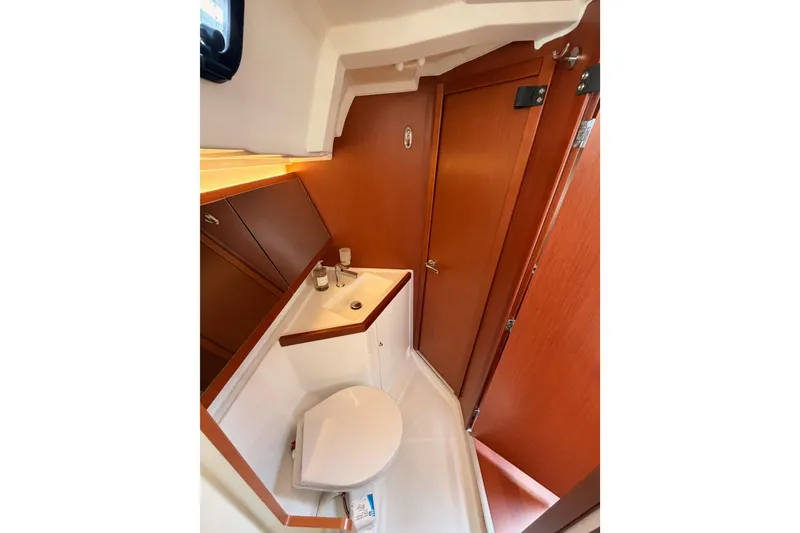 Slide: The Image of Beneteau Oceanis 46.1 2020 yacht bathroom with wooden cabinetry and compact design. - 75