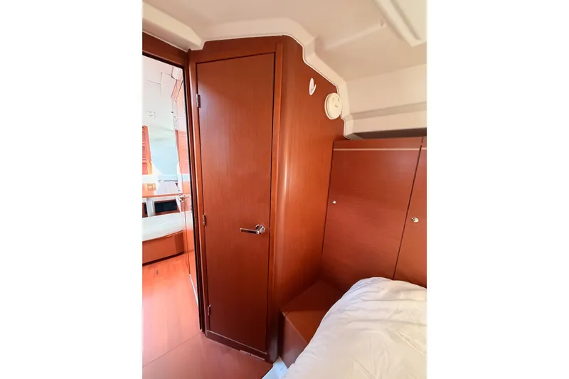 Slide: The Image of Interior cabin of 2020 Beneteau Oceanis 46.1 yacht, featuring wooden door and cozy bed. - 79