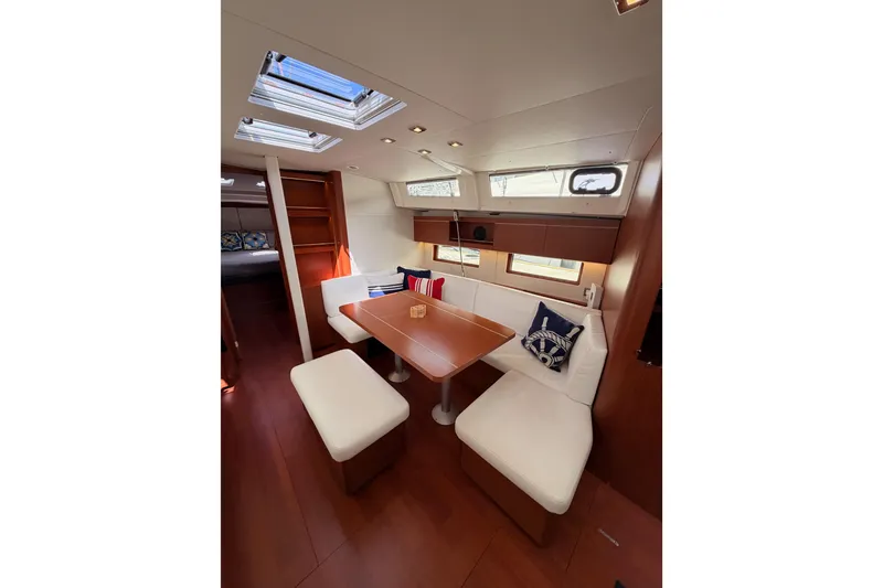 Slide: The Image of Interior of 2020 Beneteau Oceanis 46.1 yacht, featuring elegant dining area with skylights. - 83