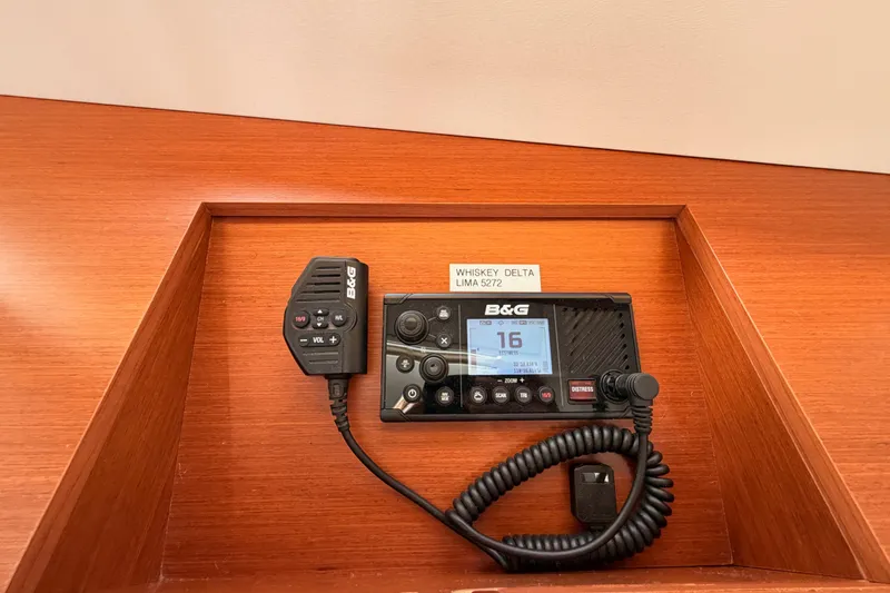 Slide: The Image of B&G marine radio on 2020 Beneteau Oceanis 46.1 yacht, wooden panel background. - 87