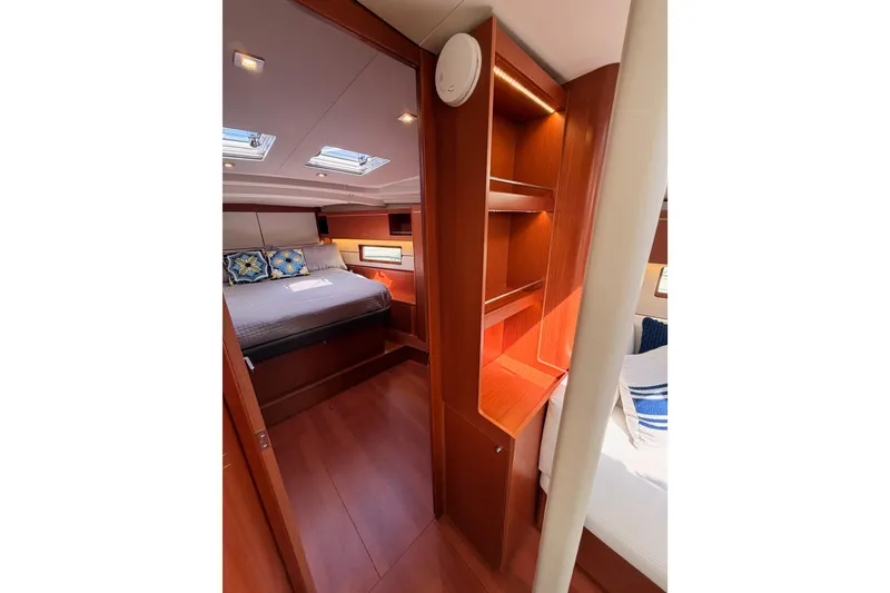 Slide: The Image of Luxurious interior of 2020 Beneteau Oceanis 46.1 yacht with cozy bedroom and wooden furnishings. - 89