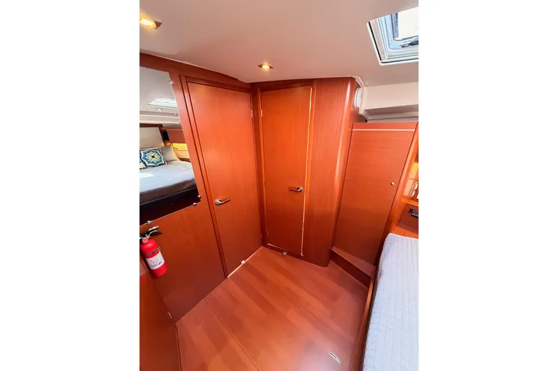 Slide: The Image of Interior of 2020 Beneteau Oceanis 46.1 yacht cabin with wooden finish and cozy bedding. - 95