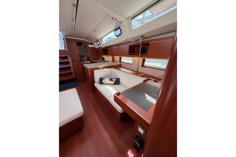 Slide: The Image of Interior of 2020 Beneteau Oceanis 46.1 yacht, featuring elegant wood finishes and modern seating. - 99