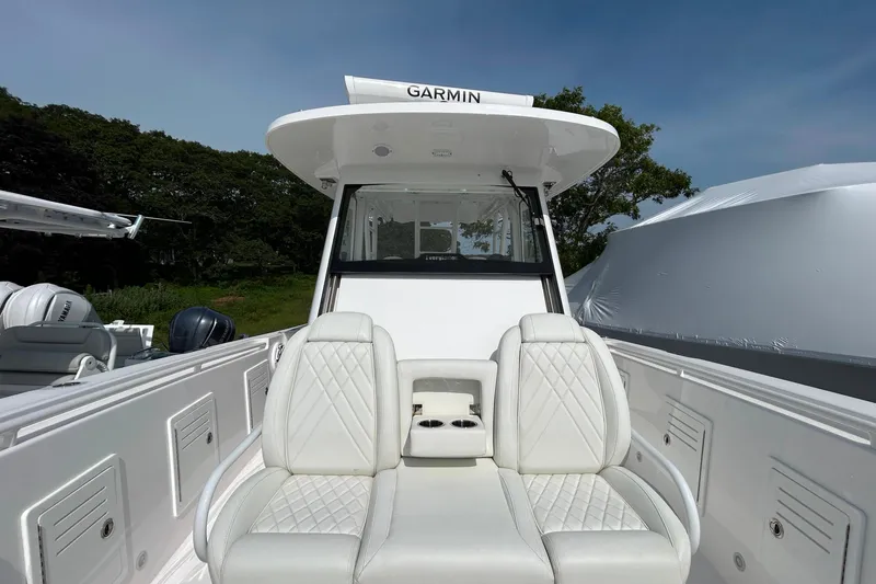 Slide: The Image of 2024 Everglades 365 Center Console boat with white seating and Garmin equipment. - 29