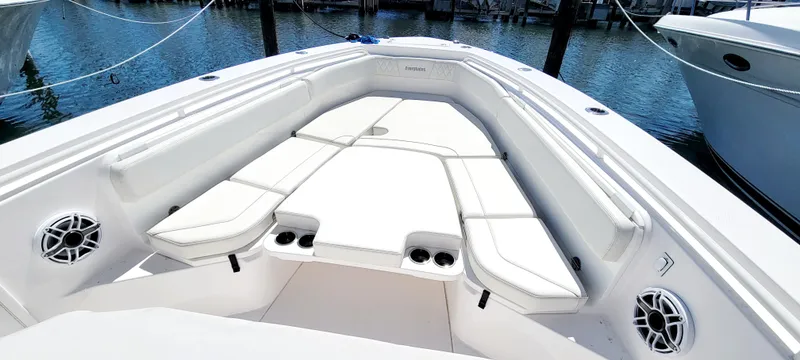 Slide: The Image of 2024 Everglades 365 Center Console boat interior with white seating and speakers. - 10
