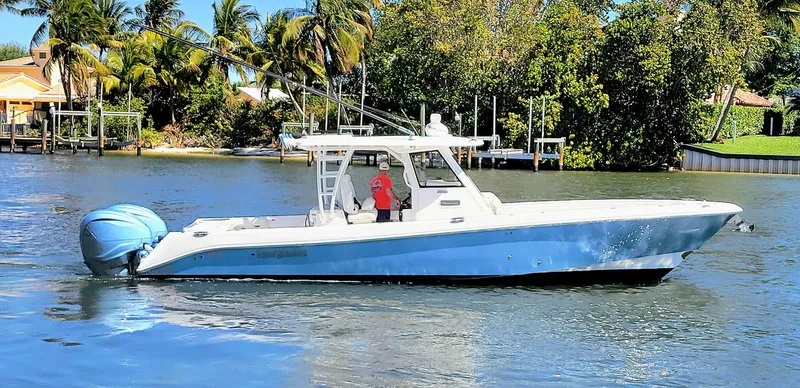 Slide: The Image of 2024 Everglades 365 Center Console boat on a scenic waterway. - 2