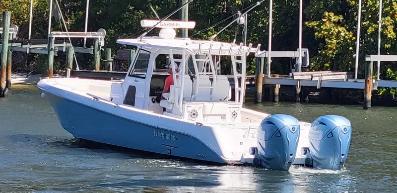 Slide: The Image of 2024 Everglades 365 Center Console boat with twin engines on the water. - 3