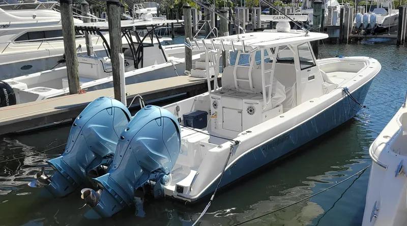 Slide: The Image of 2024 Everglades 365 Center Console boat docked with dual outboard engines. - 4