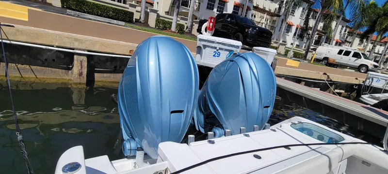 Slide: The Image of 2024 Everglades 365 Center Console with dual outboard motors docked at marina. - 5