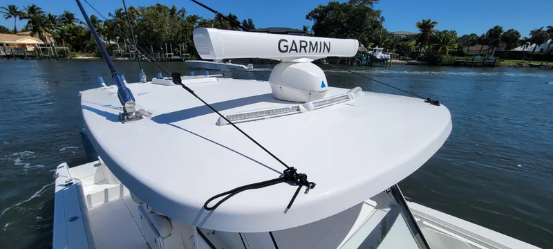 Slide: The Image of 2024 Everglades 365 Center Console boat with Garmin radar on calm water. - 8