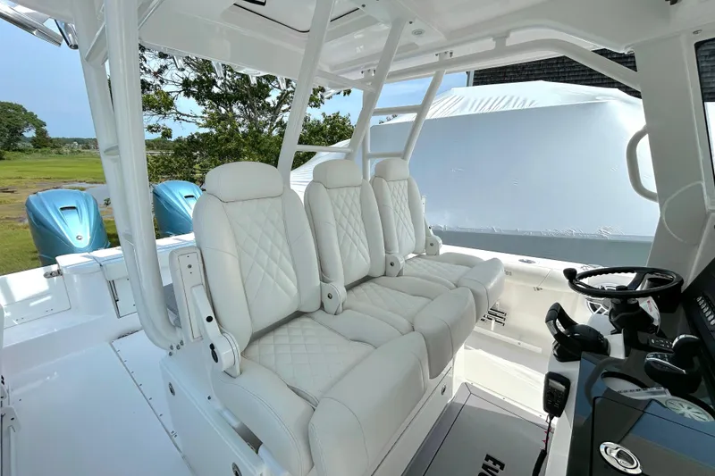 Slide: The Image of 2024 Everglades 365 Center Console boat with luxurious white seating and modern controls. - 30