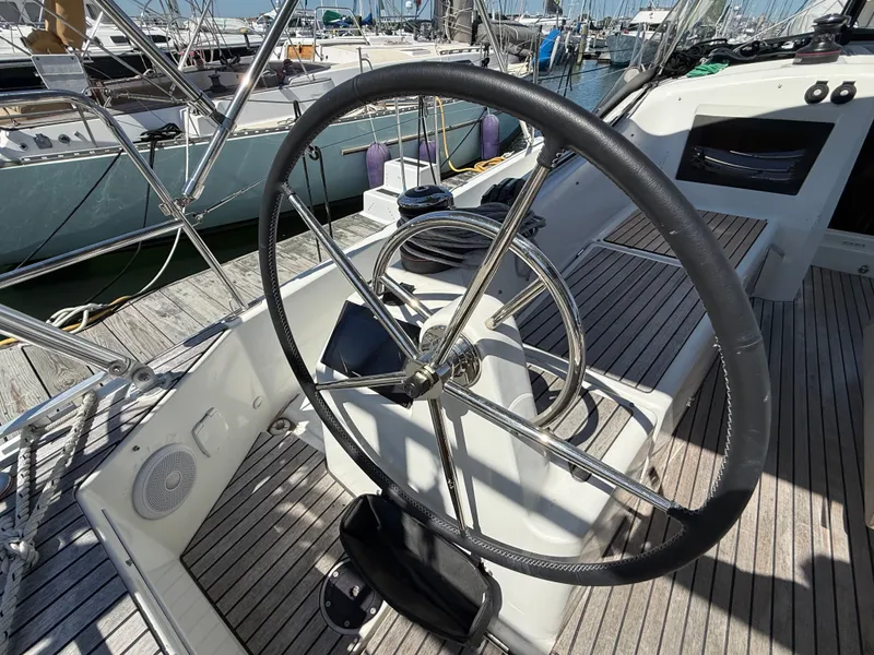 Slide: The Image of Steering wheel of Jeanneau Sun Odyssey 410, 2023 model, docked in harbor. - 11