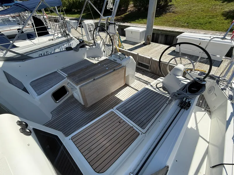 Slide: The Image of Jeanneau Sun Odyssey 410 cockpit, 2023 model, featuring wooden decks and steering wheel. - 5