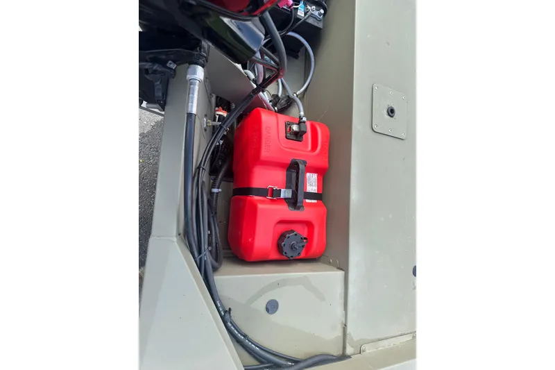 Slide: The Image of Red fuel tank in 2024 Tracker Grizzly 1648 SC boat's storage compartment. - 24