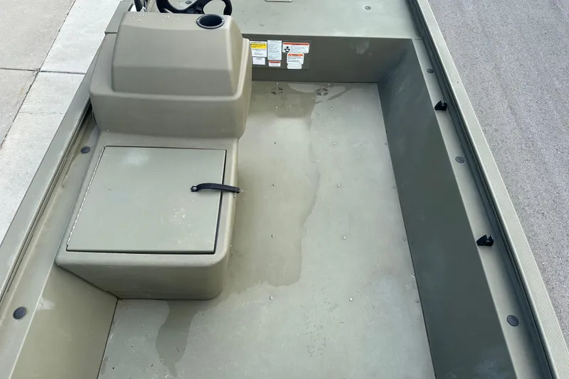 Slide: The Image of 2024 Tracker Grizzly 1648 SC boat interior with storage compartment and steering console. - 31
