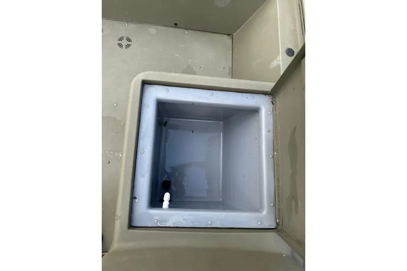 Slide: The Image of 2024 Tracker Grizzly 1648 SC boat interior showing a built-in storage compartment. - 34
