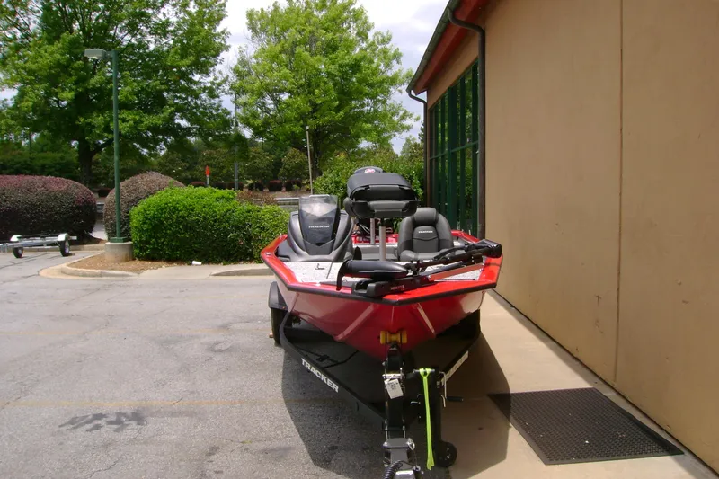 Slide: The Image of 2026 Tracker Pro Team 190 boat parked outdoors near a building. - 3