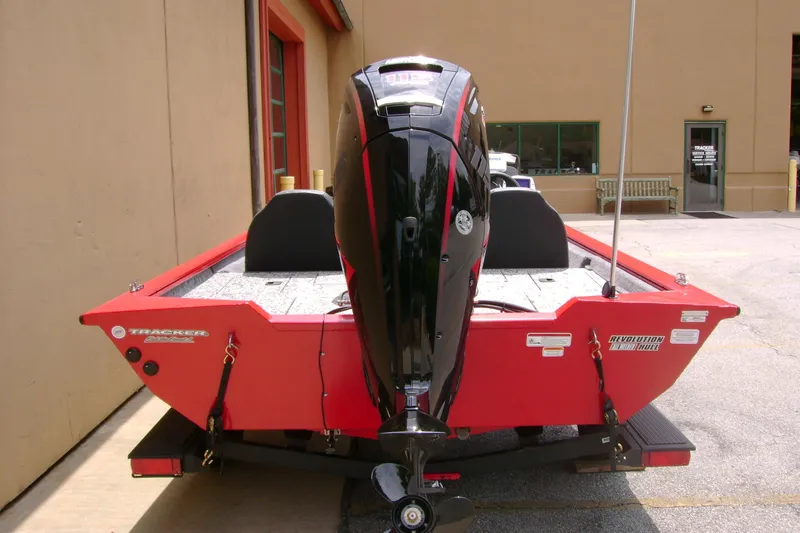 Slide: The Image of 2026 Tracker Pro Team 190 boat, red exterior, parked outside a building. - 4